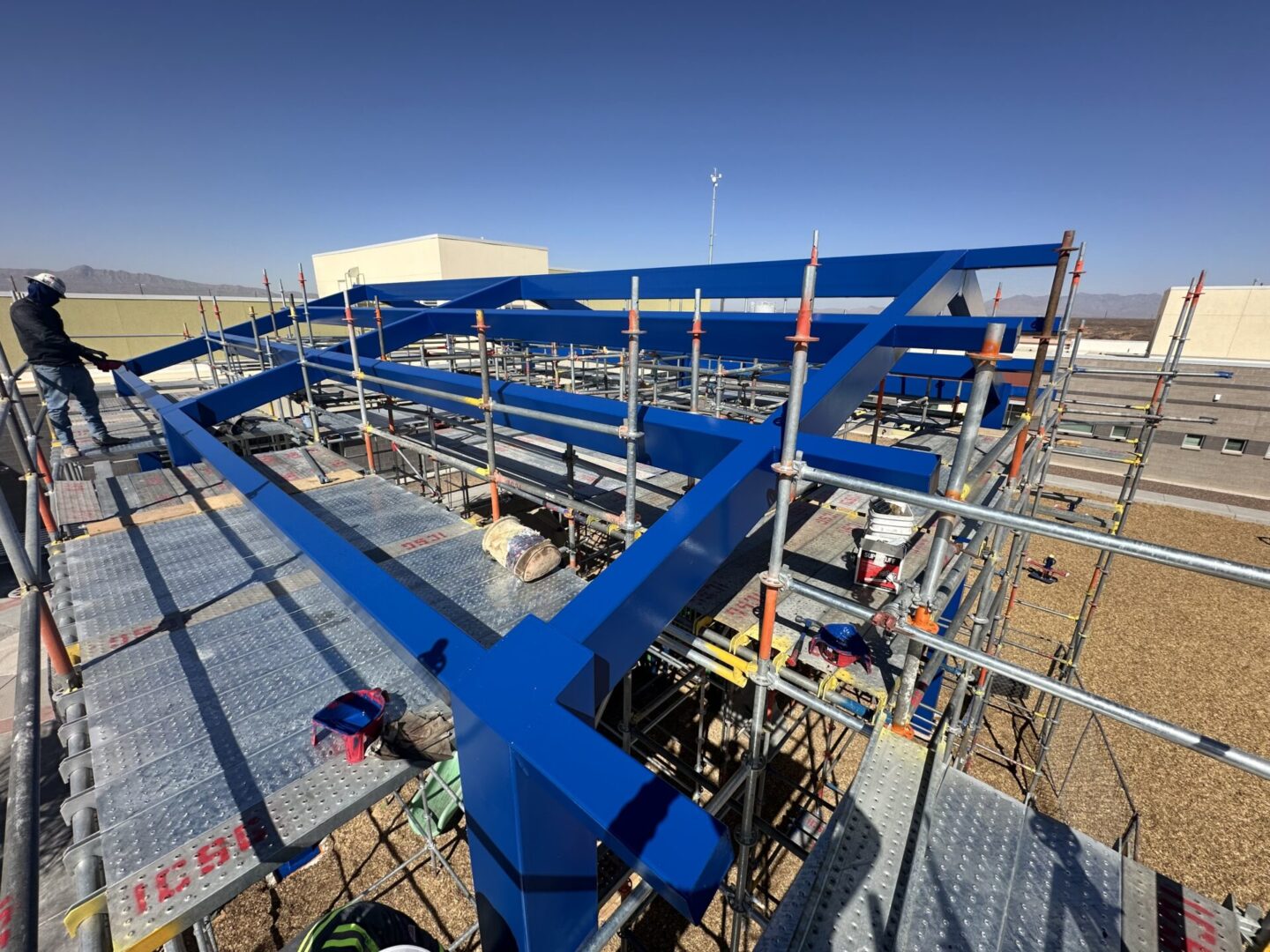 Image20250502083440 A large blue pipe sitting on top of a metal structure.